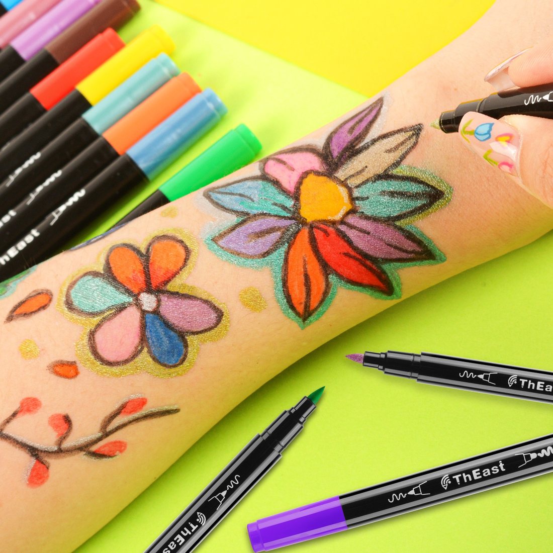 Flower design drawn on an arm with ThEast face paint markers